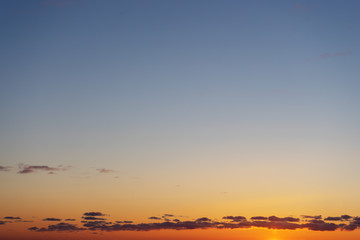 Beautiful clear, morning sky at sunrise, natural background. Soft gradient from orange to blue.