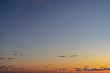Beautiful clear, morning sky at sunrise, natural background. Soft gradient from orange to blue.