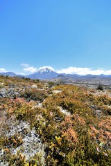 Volcano landscape in Tongariro National Park in New Zealand with a blue sky and white clouds