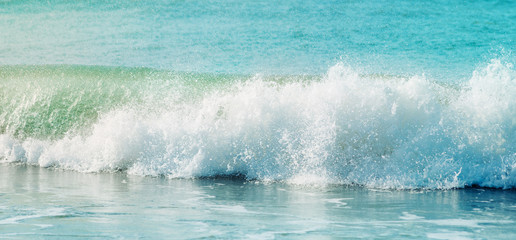 Ocean wave barrel closing and breaking with big splash