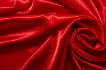 Obraz premium Luxury red satin smooth fabric background for celebration, ceremony, event invitation card or advertising poster