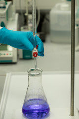 scientist working in laboratory, analysis by titration.