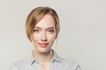 Pretty young woman smiling, female face close up on white