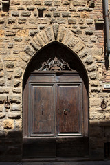 Fototapeta na wymiar Volterra (SI), Italy - April 25, 2017: An old typical wood door in Volterra town, Tuscany, Italy