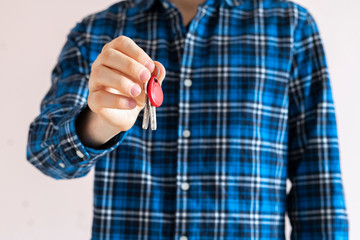Fototapeta premium close up agent house seller hand hold and give the new mansion keys, isolated, simple move concept