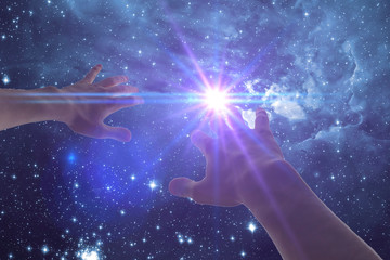 a human hand cover the light stroke frome the night star sky. elements of this image furnished by...