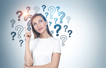 Pensive college girl, question marks