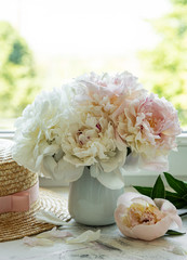 Straw hat and peonies