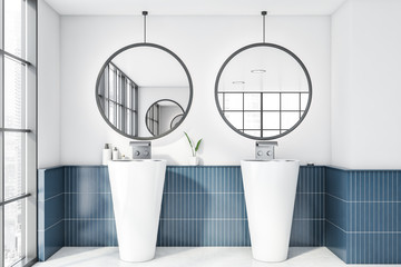 White and blue bathroom interior with double sink