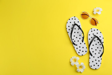 Flat lay composition with flip flops on yellow background. Space for text - obrazy, fototapety, plakaty