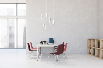 White loft office interior with red chairs