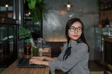 Woman working on laptop in cafe