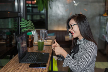 Woman working on laptop in cafe