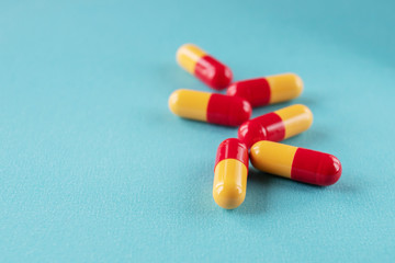 Yellow red pills on a blue background