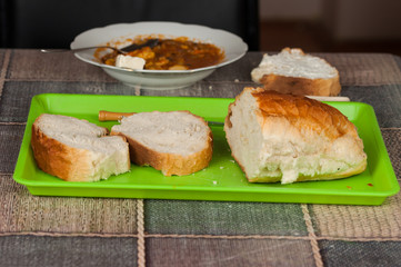 Cooked dish on a plate and bread set on a table