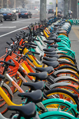 Rental bicycles are brightly for urban ride-sharing and Commuting, lined up on the sidewalks in large cities.