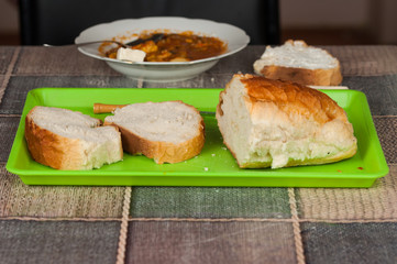Cooked dish on a plate and bread set on a table