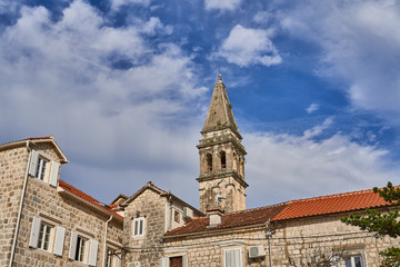 Fototapeta na wymiar bell tower of the church against the sky in the city of Perast