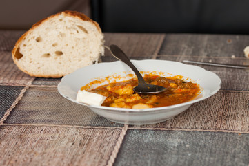 Cooked dish on a plate and bread set on a table