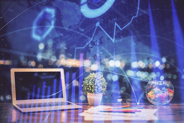 Forex graph hologram on table with computer background. Double exposure. Concept of financial markets.