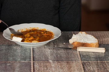 Cooked dish on a plate and bread set on a table