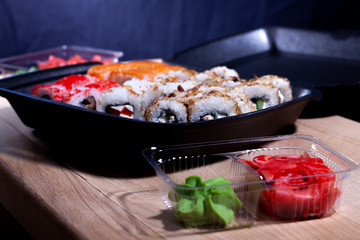 Rolls and sushi in a single container. food delivery to your home.