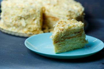 homemade Napoleon cake with cream on a gray background