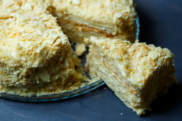 homemade Napoleon cake with cream on a gray background