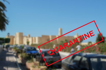 Text of the quarantine against the background of urban architecture in Tunisia