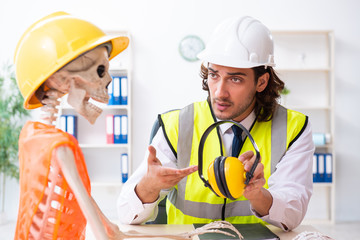 Funny construction business meeting with boss and skeletons