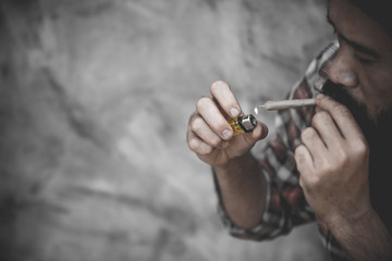 Close up man smoking a marijuana joint