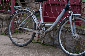 Fototapeta na wymiar A gray woman's bicycle leaning against a metal railing