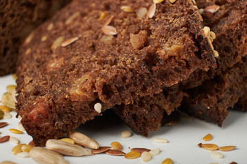 fresh bread with various seeds (pumpkin, dried apricots, flax, sunflower, sesame, prunes) is...