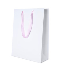 Paper shopping bag with pink handle isolated on white