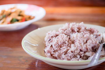 Rice berry on dish on wooden table