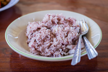 Rice berry on dish on wooden table