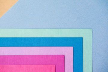 Mixing blue, turquoise and pink in the form of a triangle design paper. The view from the top.