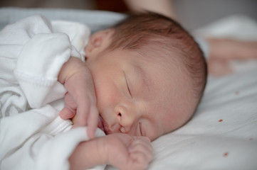 Newborn baby sleeping on bed.Family and love concept.Asian kid.