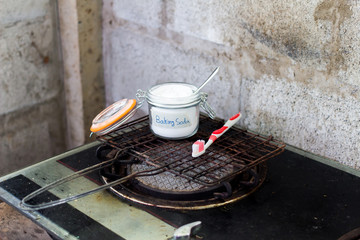 Baking soda and cleaning tools on rusty barbecue grill