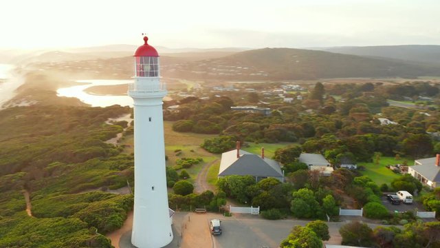 Aerial orbit around lighthouse at sunset on Australian Surf Coast