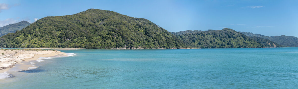 sand beach and green coast at Awaroa bay near Kaiteriteri, Abel Tasman park, New Zealand