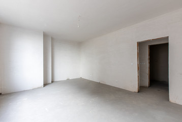 New empty room under construction. Plaster walls. New home. Concrete walls. Interior renovation.
