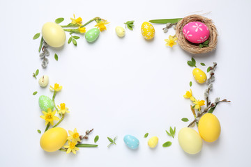 Frame made with Easter eggs on white background, flat lay. Space for text