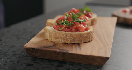 bruschetta with cherry tomatoes and spinach leaves