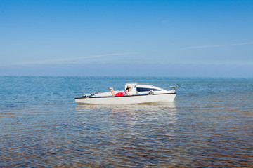 Young and handsome woman with laptop computer on sailboat. Freelance work concept