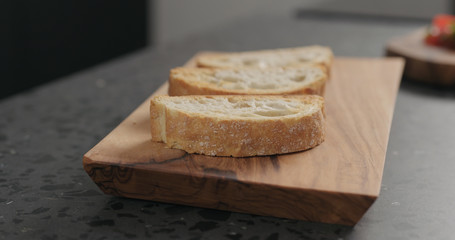 ciabatta bread on olive board
