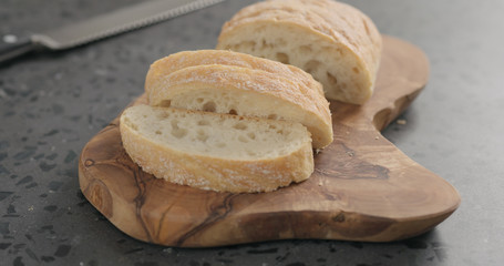 ciabatta bread on olive board