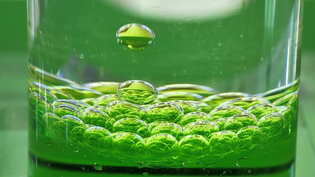 Clear liquid mixed with green colored chemical reagent