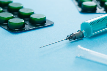 Syringe and pills in blister closeup. Medical concept of Virus Pandemic Protection, Coronavirus COVID-19