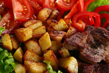 Meat plate with potatoes and souce